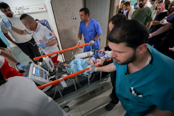 Palestinian medics rush a wounded baby on a stretcher through a hospital corridor in Hebron in the occupied West Bank, on June 5, 2026. A seven-month-old baby was critically wounded and his parents were injured during an Israeli military operation in the Wadi al-Hariya area. (Photo by Mosab Shawer / Middle East Images / AFP via Getty Images)