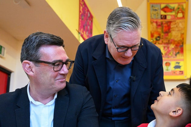 Keir Starmer and Andy Burnham meet with school children at a primary school in Ashton-under-Lyne in April.