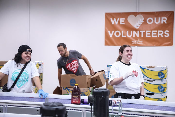 Lessons from past democracies emphasize the importance of public service, said Manville and Ober. Volunteers prepare meals with a Florida food back on June 5.