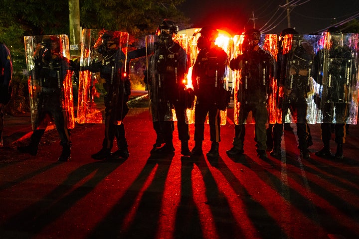 Law enforcement officers in riot gear stand off against anti-ICE protesters outside the Delaney Hall detention center in Newark, N.J., on May 30, 2026.