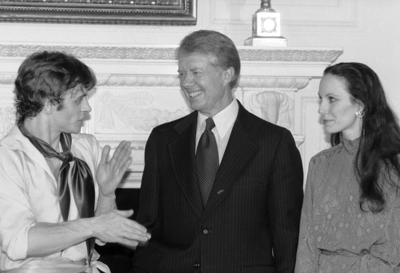 Dancer Mikhail Baryshnikov (left) explains to President Jimmy Carter how he performs his dance act after his performance for the First Family in the East Room of the White House in Washington, D.C., in1979. Standing at the right is fellow dancer Patricia McBride.