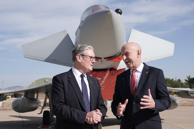 Britain's Prime Minister Keir Starmer, lef and Defence Secretary John Healey stand in front of a UK Typhoon fighter jet at Tusas airbase, in Ankara, Turkey, Monday, Oct. 27, 2025. (Stefan Rousseau/Pool Photo via AP)