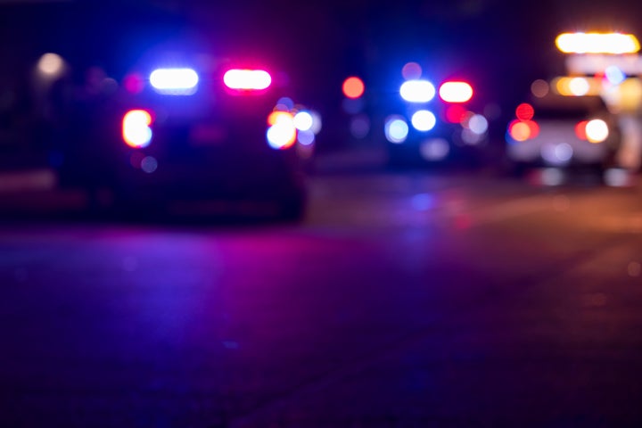 Abstracted night time view of police units repsonding to an emergency.