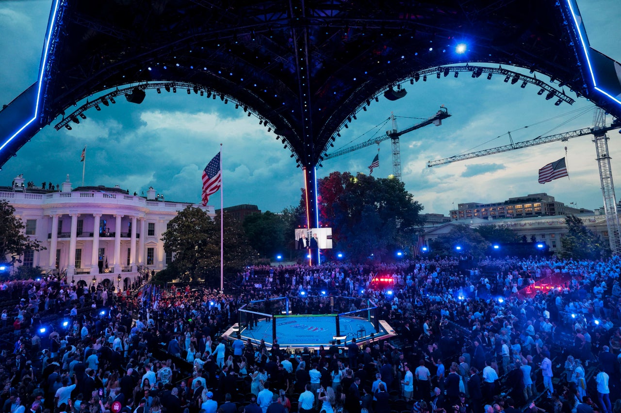 A screen shows President Trump walking with UFC CEO Dana White during the "UFC Freedom 250" event.