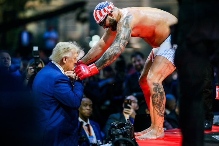UFC fighter Josh Hokit gives President Donald Trump a medallion following his win in a heavyweight fight during the UFC Freedom 250 event on the South Lawn at the White House on June 14, 2026 in Washington, DC.