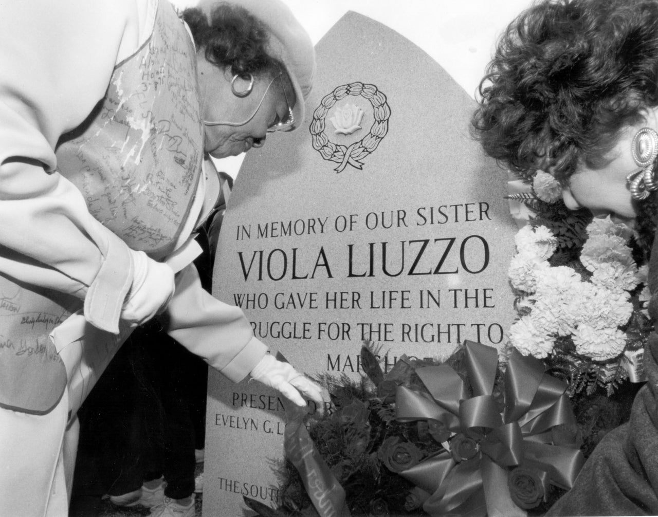 Marie Foster, left, and Evelyn Lowery, right, place a wreath at the site where Detroit civil rights activist Viola Liuzzo was killed by Ku Klux Klansmen after the Selma to Montgomery march, on Highway 80 near Lowndesboro, Alabama, on March 18, 1995.