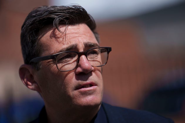 Andy Burnham speaks with police personnel during a campaign visit to the town of Ashton-in-Makerfield before the forthcoming Makerfield by-election, in Greater Manchester, England, Tuesday, June 9, 2026.