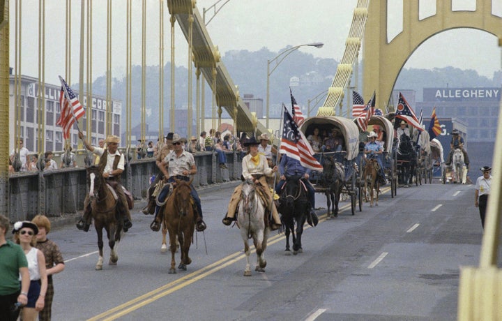 The bicentennial Wagon Train crosses the Allegheny River in downtown Pittsburgh, Pa., headed for Valley Forge and the nation's 200th birthday celebration, June 14, 1976.