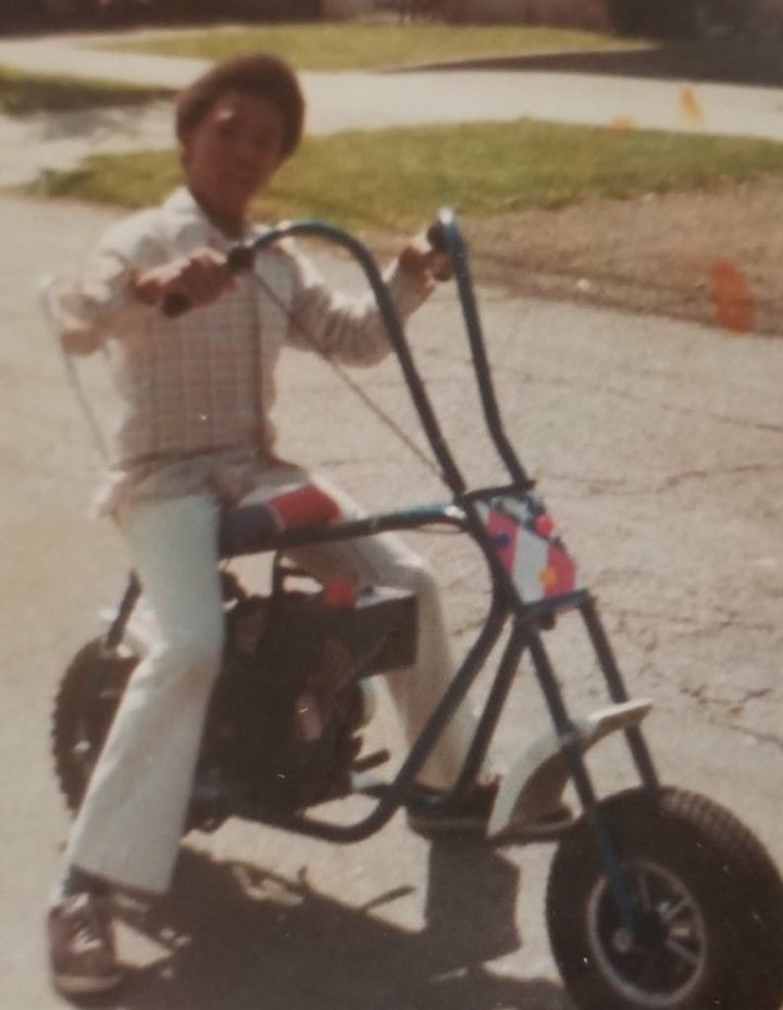Myron Clifton, age 12, on his red, white and blue minibike.