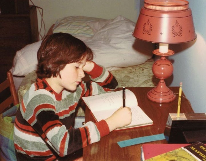 Paul Haddad, at 10 years old in 1976, writing a "book" in his bedroom.