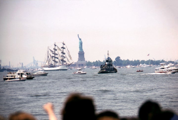 Spectators watch Operation Sail, a parade of 16 majestic tall ships from 14 nations to celebrate the United States Bicentennial, near the Statue of Liberty in New York Harbor. Taken on July 4, 1976 in New York City, New York. (Photo by David Attie/Getty Images.)