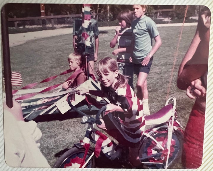 Jennifer Keith's sister Amy, dressed as the American flag, on a bike festooned with ribbons.