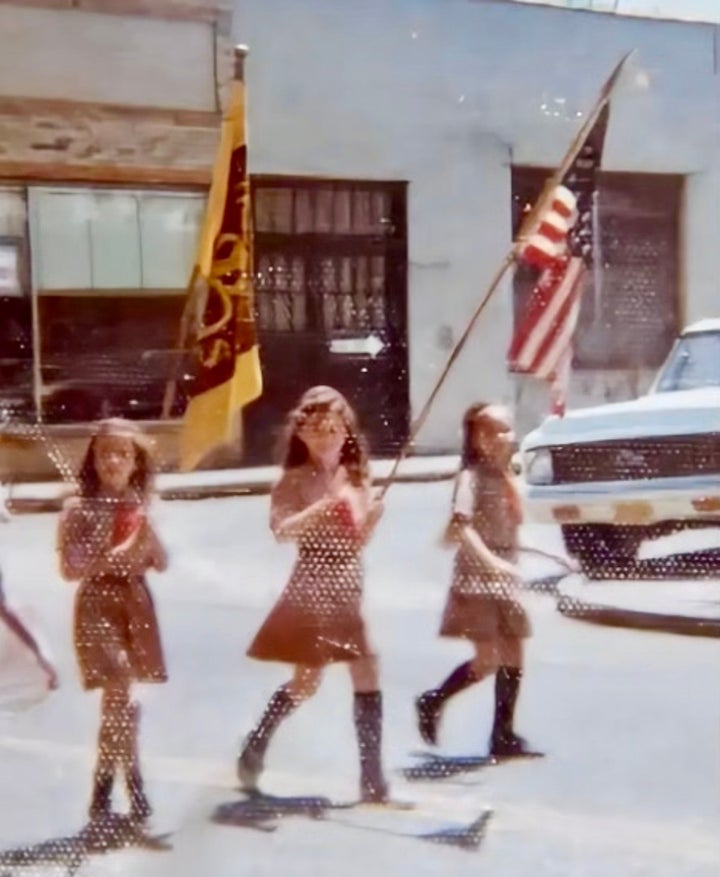 Susan Giuliani as a child holding an American flag in a bicentennial parade.