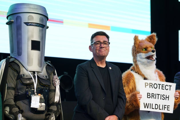 Labour party's Andy Burnham stands beside candidate Count Binface, left, and a candidate for Protect British Wildlife after winning the Makerfield by-election, paving the way for a leadership challenge against Prime Minister Sir Keir Starmer. in Wigan, England, Friday, June 19, 2026.
