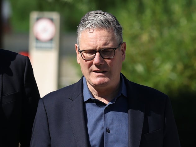 Britain's Prime Minister Keir Starmer walks, as he visits a housing development in north London, Friday, June 19, 2026. 