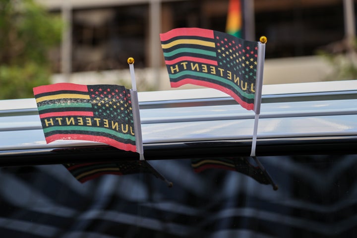 Flags are held during a Juneteenth celebration and parade in San Francisco, California, last year.