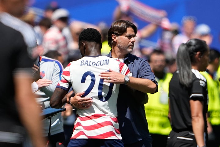 Head coach Mauricio Pochettino embracing U.S. men's national team player Folarin Balogun.