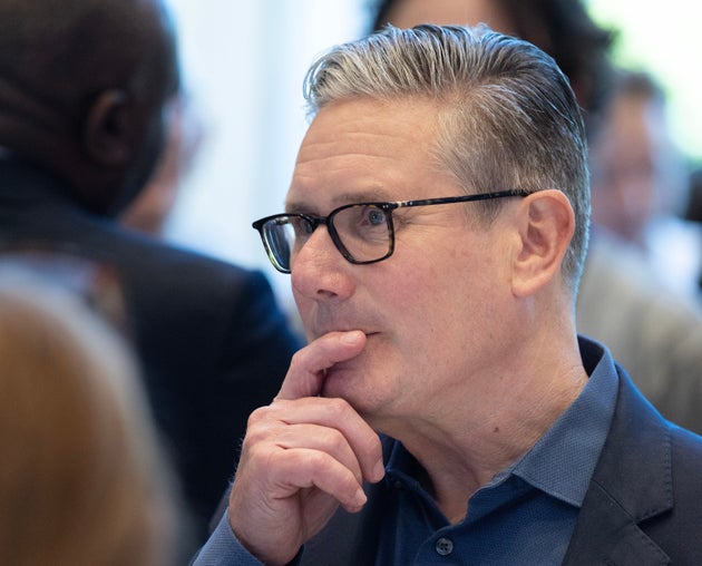 Britain's Prime Minister Keir Starmer gestures as he visits a housing development in north London, Friday, June 19, 2026. (Peter Macdiarmid/Pool Photo via AP)