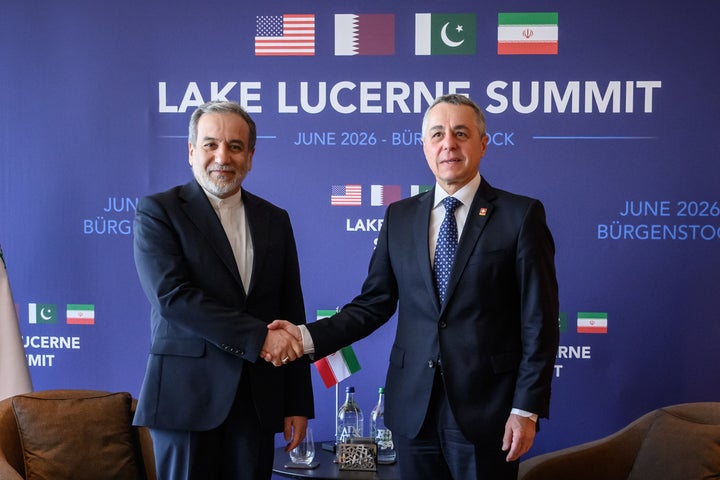 Iran's Foreign Minister Abbas Araghchi (L) shakes hands with Switzerland's Foreign Minister Ignazio Cassis at the Burgenstock luxury hotel complex overlooking Lake Lucerne, Switzerland, on June 21, 2026, ahead of high-level talks aimed at advancing a deal to end the Middle East conflict. A new round of negotiations over the Middle East war was set to kick off on June 21, 2026 with Iranian negotiators arriving in the Swiss host city hours ahead of US Vice President JD Vance, even as Tehran said it was closing the Strait of Hormuz again over Israeli attacks in Lebanon. (Photo by Fabrice Coffrini / POOL / AFP via Getty Images)