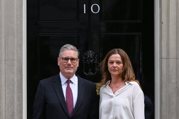 Britain's Prime Minister Keir Starmer and wife Victoria stand in front of 10 Downing Street door after after announcing his resignation in London, Monday, June 22, 2026.