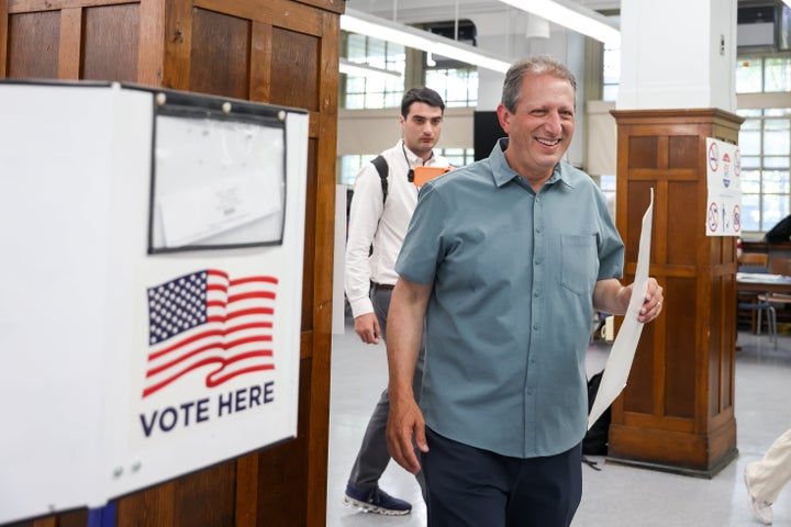 Brad Lander (right), casts a ballot at a polling location inside John Jay High School during early voting for a primary election in the Brooklyn borough of New York on Sunday.