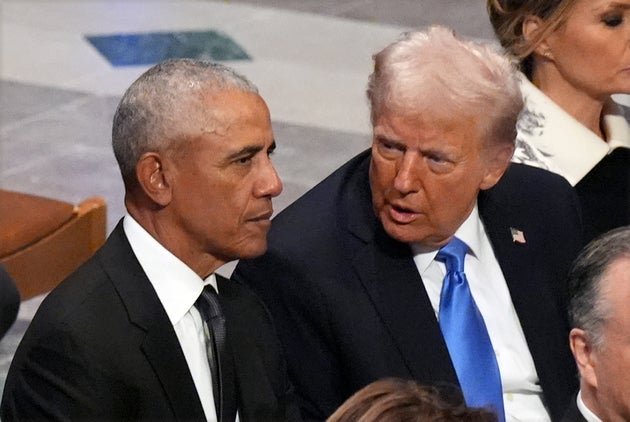 Former President Barack Obama talks with President-elect Donald Trump before the state funeral for former President Jimmy Carter at Washington National Cathedral in Washington, Thursday, Jan. 9, 2025.