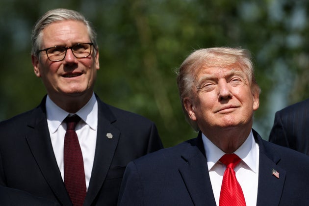 British Prime Minister Keir Starmer, left, and U.S. President Donald Trump pose for a group photo at the G7 summit in Evian-les-Bains, France, Tuesday June 16, 2026. (Isabel Infantes/Pool Photo via AP)