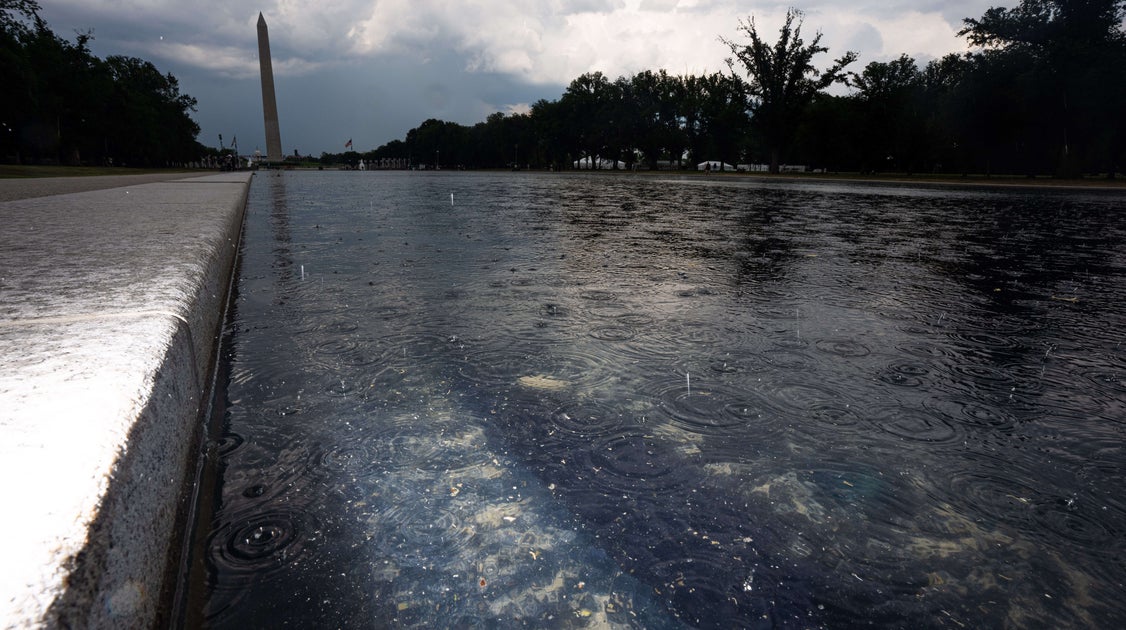 Workers Seen Putting Up Metal Fencing Near Reflecting Pool