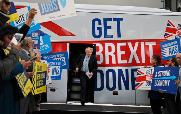 Prime Minister Boris Johnson addresses his supporters prior to boarding his General Election campaign trail bus in Manchester, England, Friday, Nov. 15, 2019. 