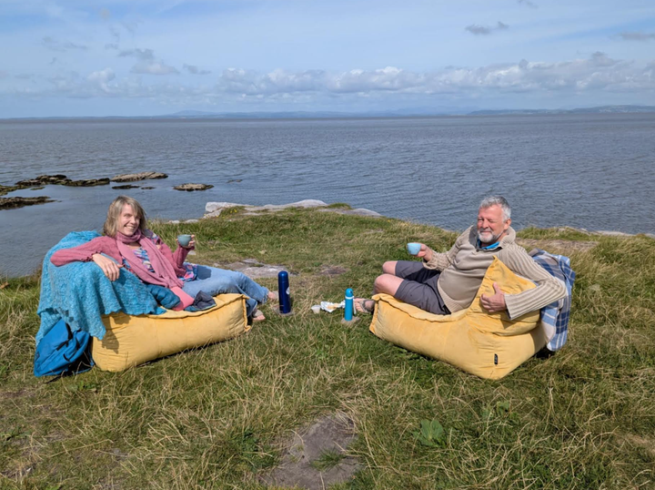 The author (left) having a cup of tea on the edge of a cliff.