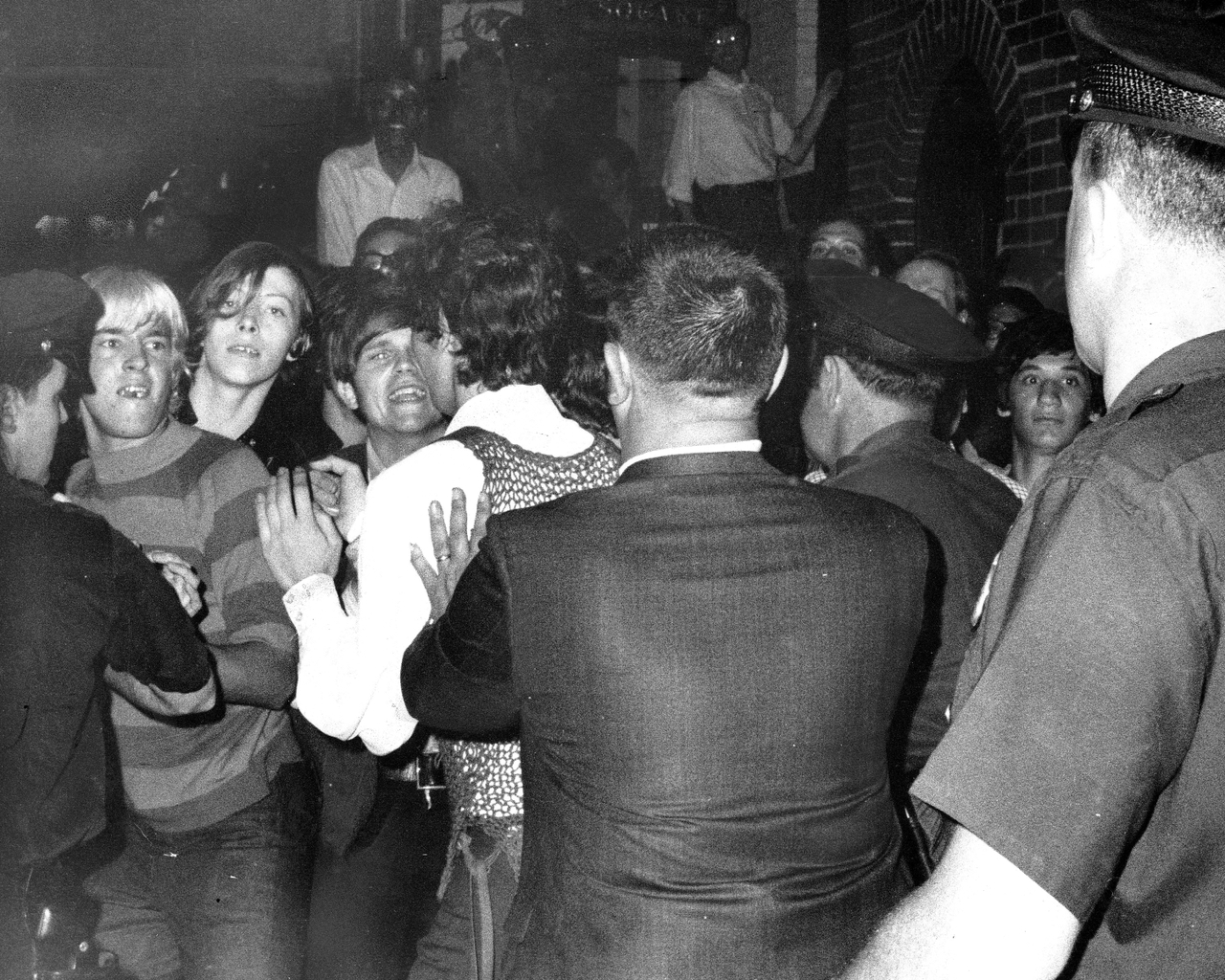 Stonewall Inn nightclub raid. Crowd attempts to impede police arrests outside the Stonewall Inn on Christopher Street in Greenwich Village.
