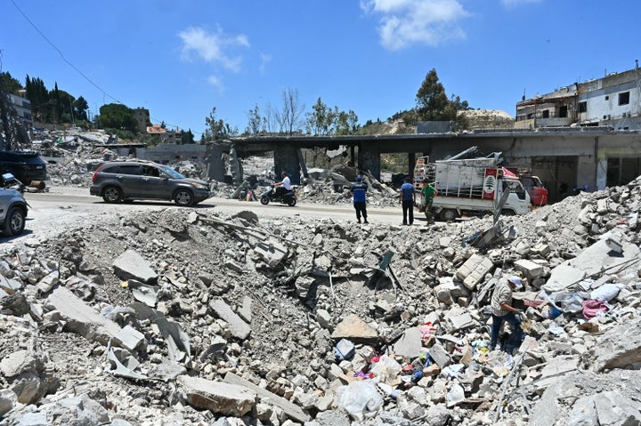 Residents arrive to inspect what is left of their homes and businesses, destroyed in Israeli military strikes, in the southern Lebanese village Bir Al-Salasil on June 24, 2026.