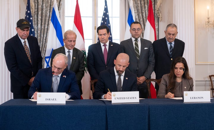 Secretary of State Marco Rubio and others watch, seated from left, Israel's Ambassador to the U.S. Yechiel Leiter, counselor Dan Holler, and Lebanon's Ambassador to the U.S. Nada Hamadeh, sign a framework agreement, described as a first step toward peace following months of conflict between Israel and the Lebanese militant group Hezbollah, at the State Department, Friday, June 26, 2026, in Washington. (AP Photo/Kevin Wolf)