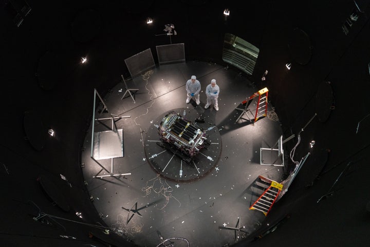Kieran Wilson, LINK’s principal investigator, and Hunter Robertson, a space systems engineer, stand next to their spacecraft inside the Space Environment Simulator at NASA’s Goddard Space Flight Center in Greenbelt, Md.