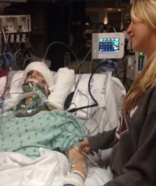 The author in a coma at IU Methodist Hospital in Indianapolis, with Chelsea at his bedside.