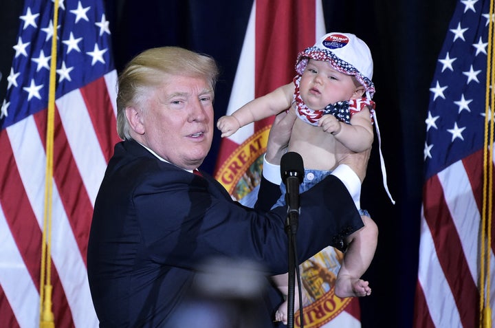 Presidential nominee Donald Trump holds a baby during a rally at the Florida State Fairgrounds in Tampa on Nov. 5, 2016.