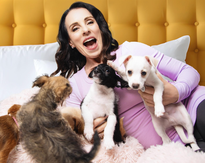 The author at home with a mix of puppies. "Some of these were from a high-kill shelter and others were puppies left in a box in the middle of an orchard in the Inland Empire," she writes.