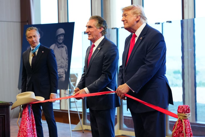President Donald Trump and Interior Secretary Doug Burgum cut a ribbon, as Britt Slabinski, president of the Congressional Medal of Honor Society, during a ceremony presenting Theodore Roosevelt's Medal of Honor that was in the Roosevelt Room at the White House House, to be kept on display at the Theodore Roosevelt Presidential Library, in Medora, N.D., Wednesday, July 1, 2026. (AP Photo/Julia Demaree Nikhinson)