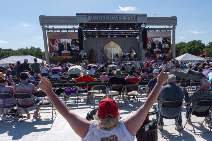 A person worships as a recorded video message from President Donald Trump plays at Rededicate 250, a mostly conservative Christian prayer gathering in honor of the United States' 250th anniversary, on the National Mall, Sunday, May 17, 2026, in Washington.