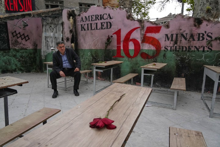 FILE - A man sits on a bench in a memorial, set for the school children who were killed during a strike on a primary school in southern town of Minab on Feb. 28, in northern Tehran, Iran, Sunday, April 12, 2026. (AP Photo/Vahid Salemi, File)