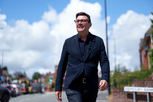 Andy Burnham smiles during a campaign visit to Ashton-in-Makerfield before the forthcoming by-election, in Manchester, England, Tuesday, June 9, 2026. 