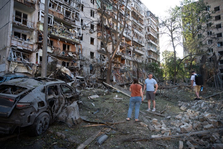 People look at a residential building damaged during the Russian missile attack in Kyiv, Ukraine, on July 2, 2026.