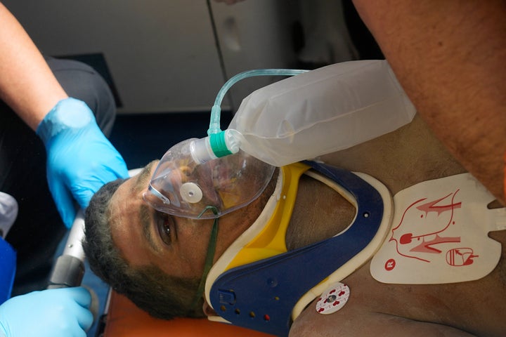 Rescue workers tend to Gil Flores.