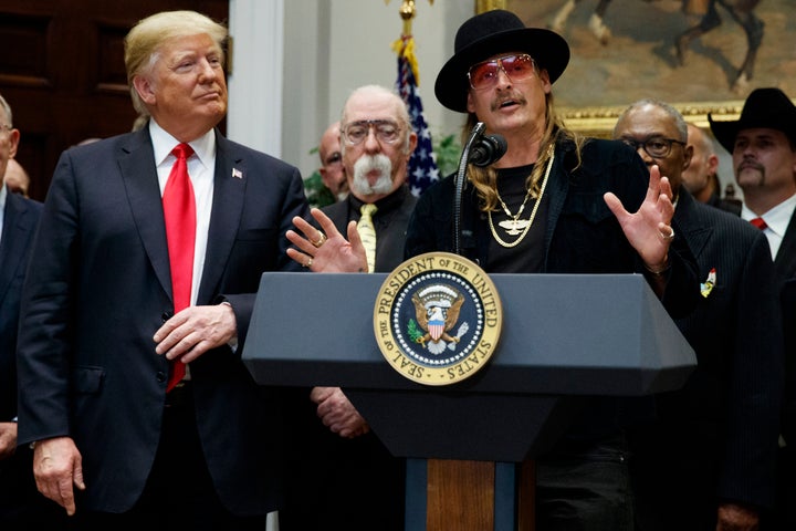 President Donald Trump looks on as musician Kid Rock speaks during a 2018 signing ceremony at the White House.