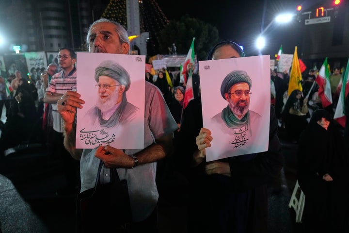 Pro-government Iranian demonstrators hold posters of the Supreme Leader Ayatollah Mojtaba Khamenei, right, and his slain father Ayatollah Ali Khamenei, who was killed in U.S. and Israeli strikes on Feb. 28, in a gathering in Tehran, Iran, on June 7, 2026.