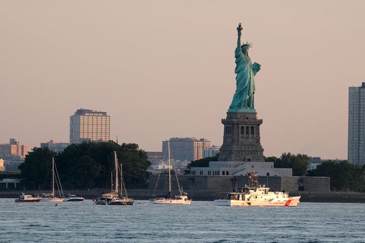 A U.S. Coast Guard vessel sits with other pleasure craft below the Statue of Liberty in the New York harbor ahead of Sail250, a gathering of tall ships and military ships honoring America's 250th Anniversary, Saturday, July 4, 2026, in New York. (AP Photo/Frank Franklin II)
