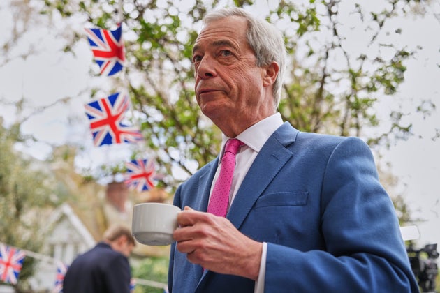 Nigel Farage, the leader of Reform UK, drinks a cup of tea as he meets supporters after a news conference in London on April 2, 2026.