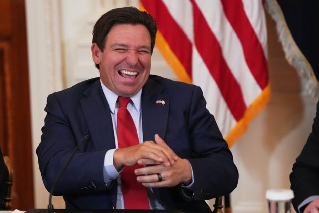 Florida Gov. Ron DeSantis laughs before a roundtable discussion on college sports in the East Room of the White House, Friday, March 6, 2026, in Washington. (AP Photo/Julia Demaree Nikhinson)