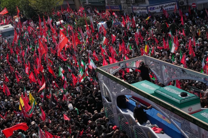 Mourners reached out to touch the truck, and some threw scarves and other items for attendants to brush against the coffin, a common practice in Iran seen as a blessing.