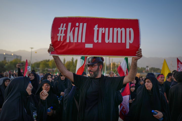 A man holds a sign reading "#kill_trump" as mourners gather for funeral ceremonies for slain Iranian Supreme Leader Ayatollah Ali Khamenei and members of his family at the Imam Khomeini Mosalla Grand Mosque in Tehran, Iran, on July 5, 2026.